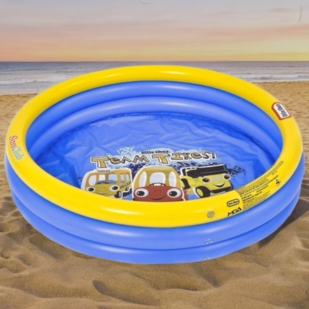 Children's inflatable pool with cartoon characters on a sandy surface
