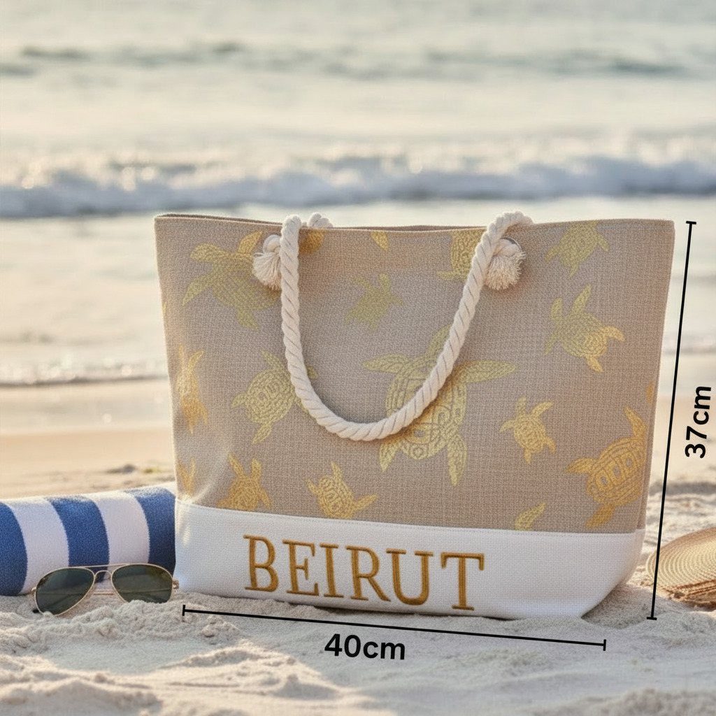 Beach bag with turtle pattern and 'BEIRUT' text on a sandy beach.