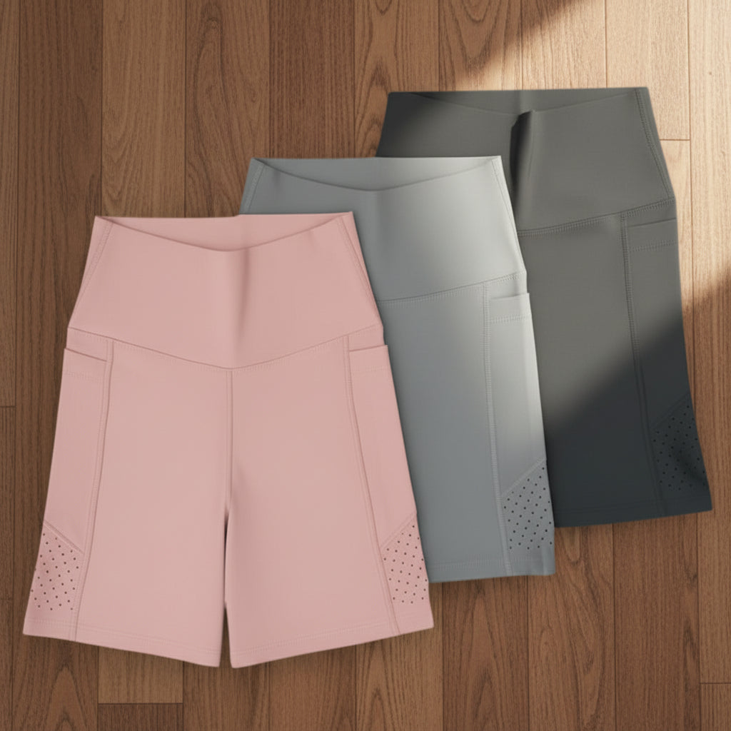 Pocket shorts in pink, grey, and black on a wooden background
