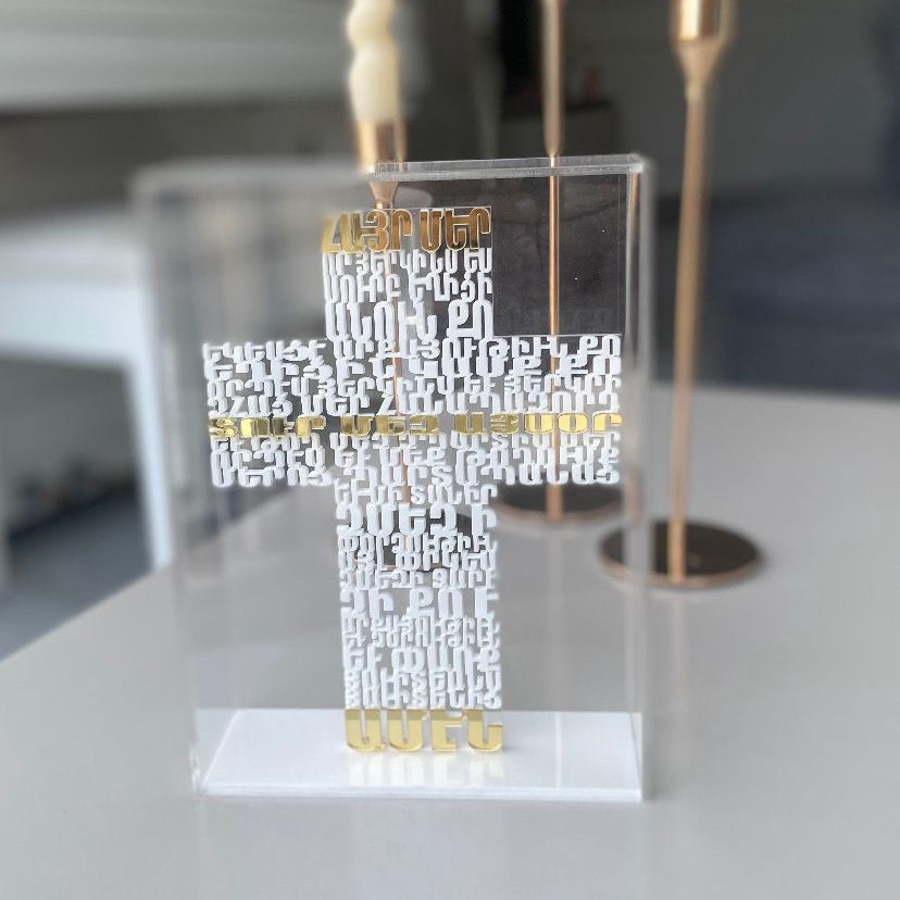 Raised white Armenian lettering forming a cross, three lines picked out in gold