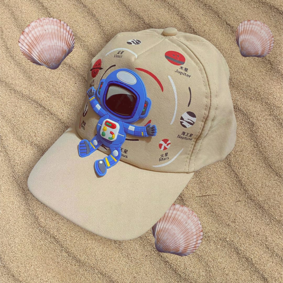 Sand coloured boys cap laid flat with a raised astronaut patch and solar system planet artwork