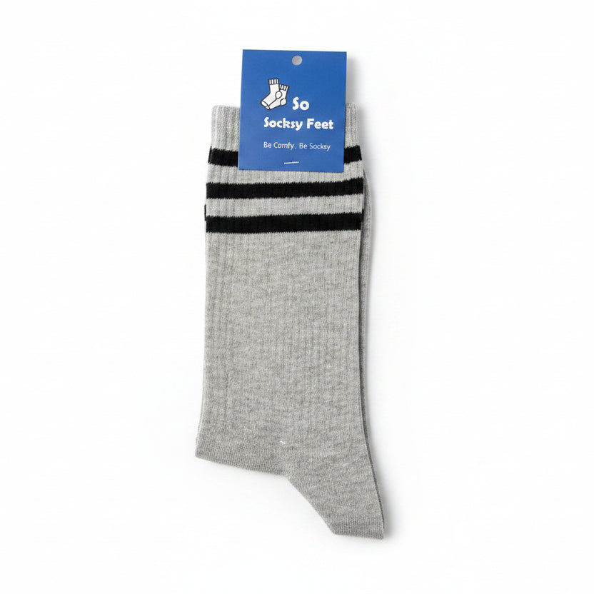Gray sock with black stripes on a white surface