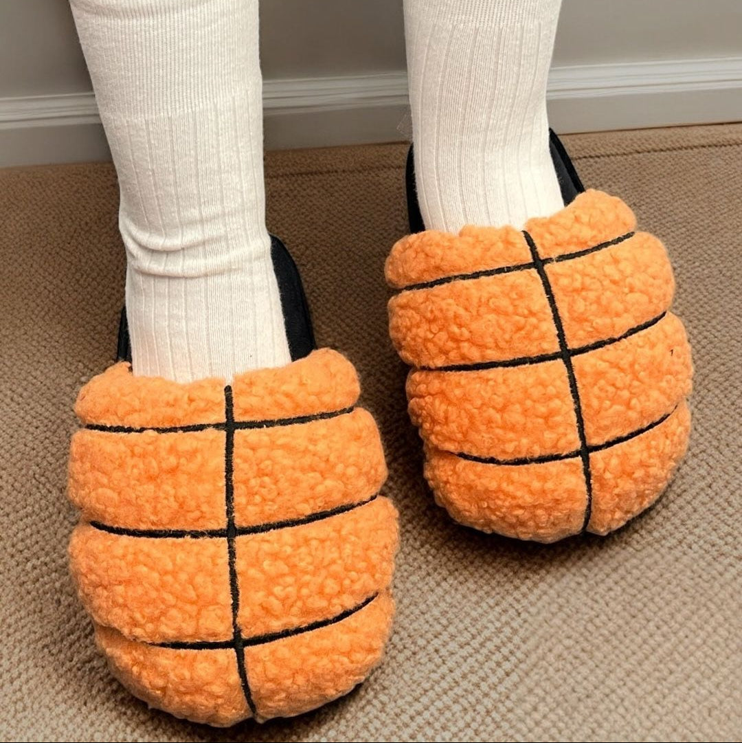 Basketball-themed slippers worn indoors on a carpeted floor
