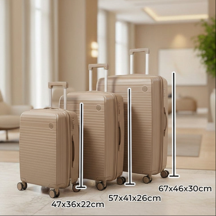 Three beige suitcases lined up by size in a bright hotel lobby
