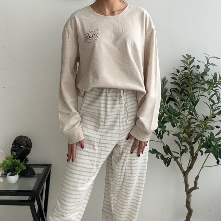 Beige marl sweatshirt top with a small cartoon cat face print and striped lounge trousers