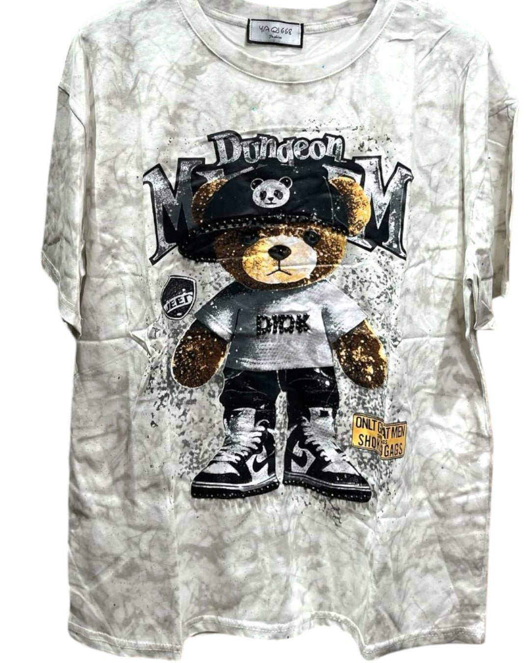 Oversized beige tie-dye tshirt with a graphic of a bear wearing a hat and lettering, and splatter details
