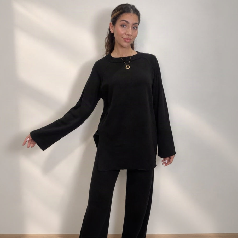 Black knit crew neck sweater with side slits and matching wide leg trousers