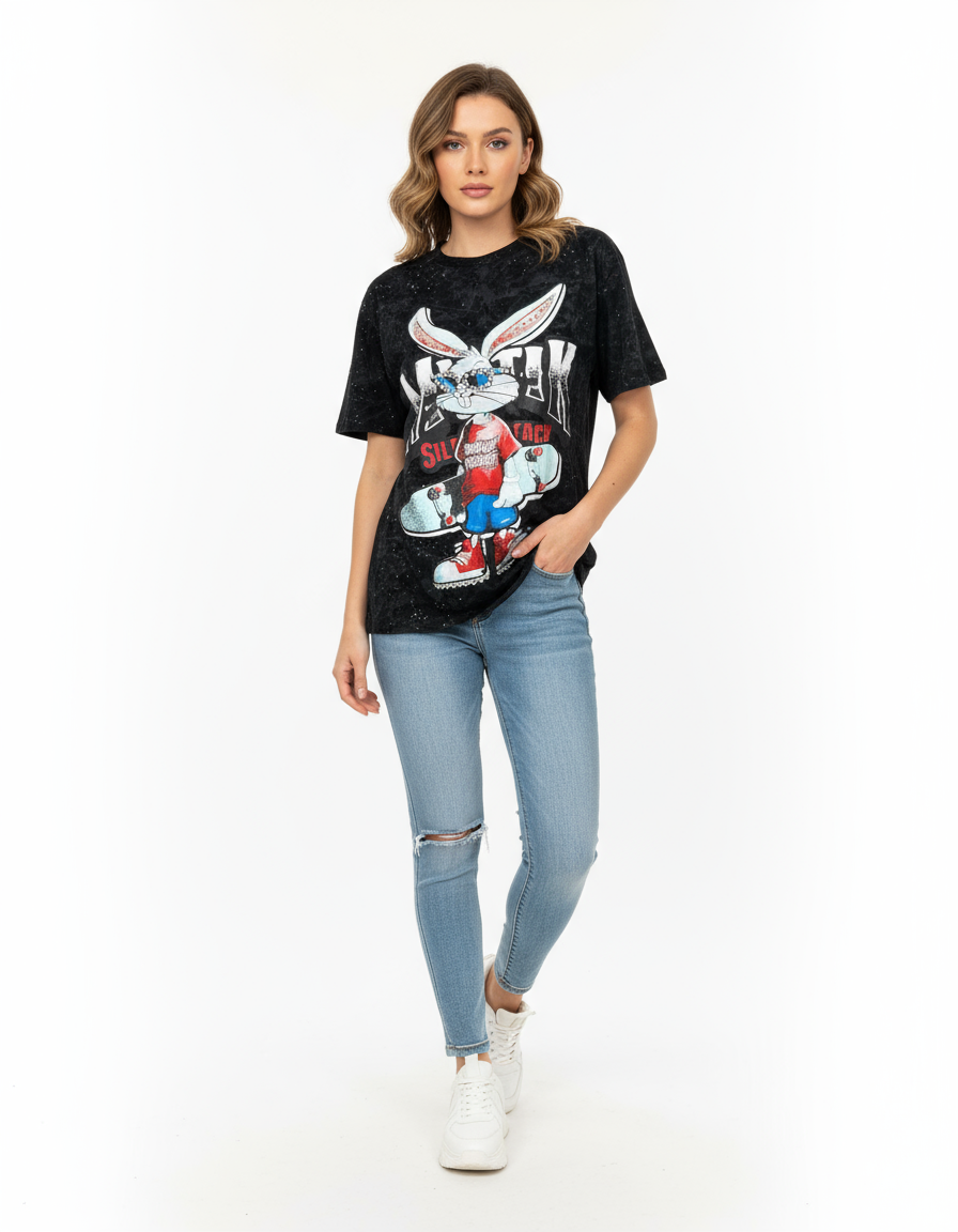 Woman wearing a black tshirt with a graphic bunny design and light blue jeans on a white background