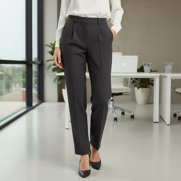 Person wearing black trousers in an office setting