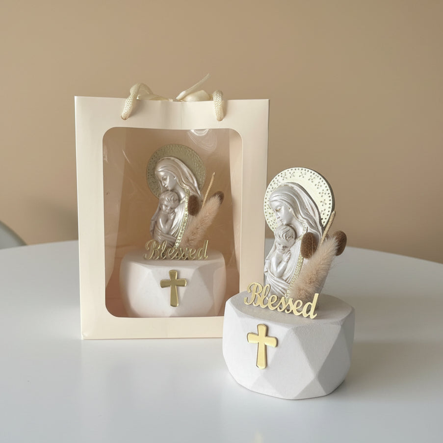 Veiled Virgin and infant relief beside a window gift bag and dried bunny tail grass