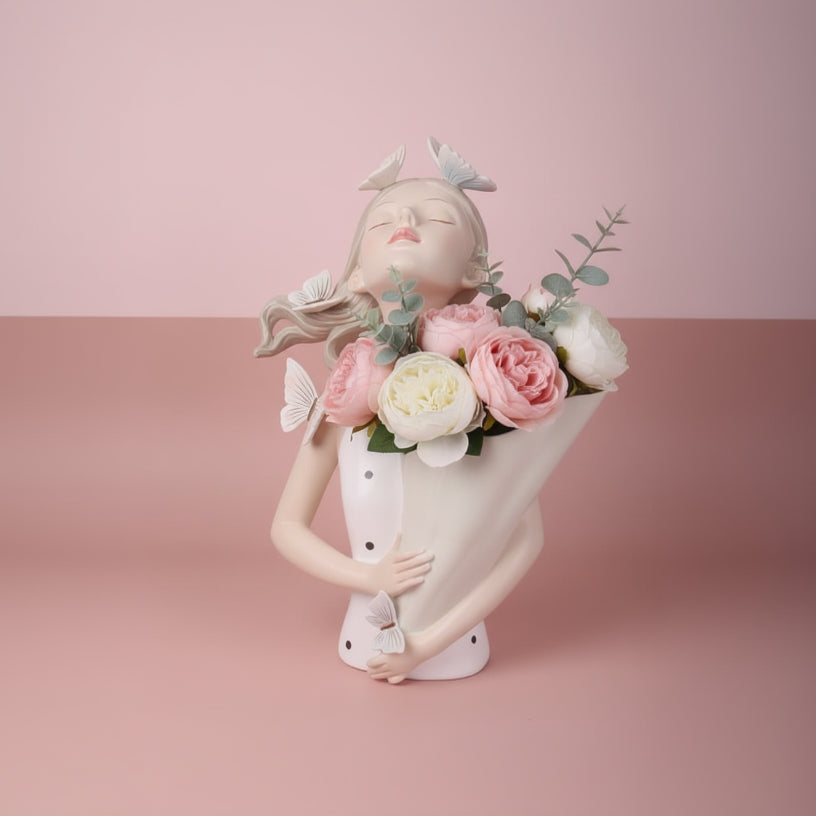 Cream bust vase with white butterflies in her hair, her paper cone full of roses