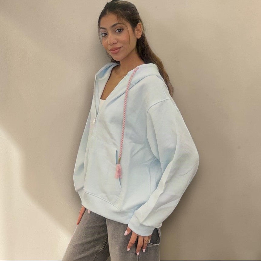 Side view of the pale blue hoodie showing the longline hem and relaxed drape