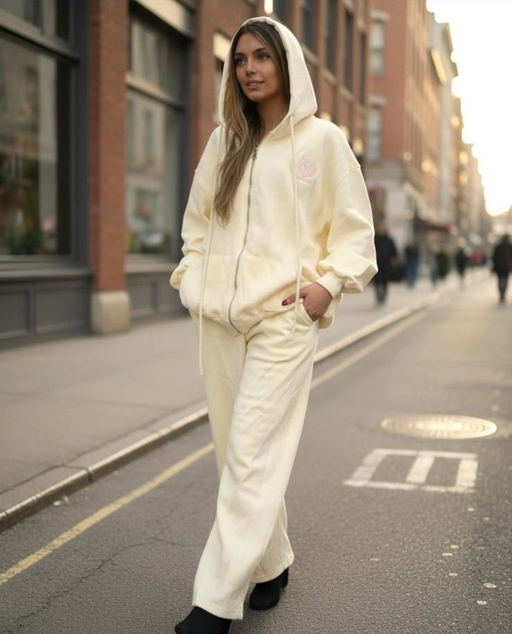Woman wearing a yellow bonnie club jogging set on a city street