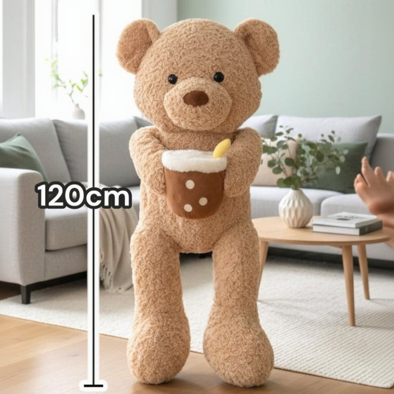 Full height view of the tan curly teddy against a 120cm scale, its pearl dotted drink plush in one arm