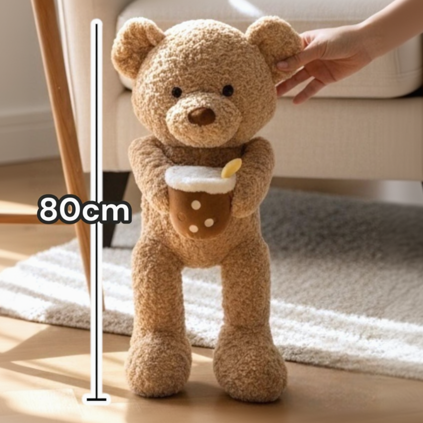 Caramel curly bear at 80cm on a measuring scale, a pearl trimmed drink plush under one paw