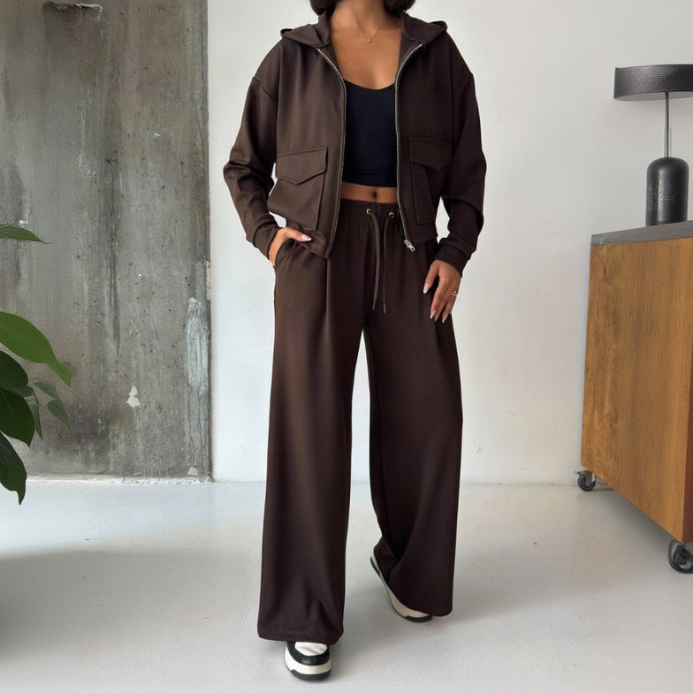 Full length view of the brown zip hoodie set with wide leg trousers and trainers