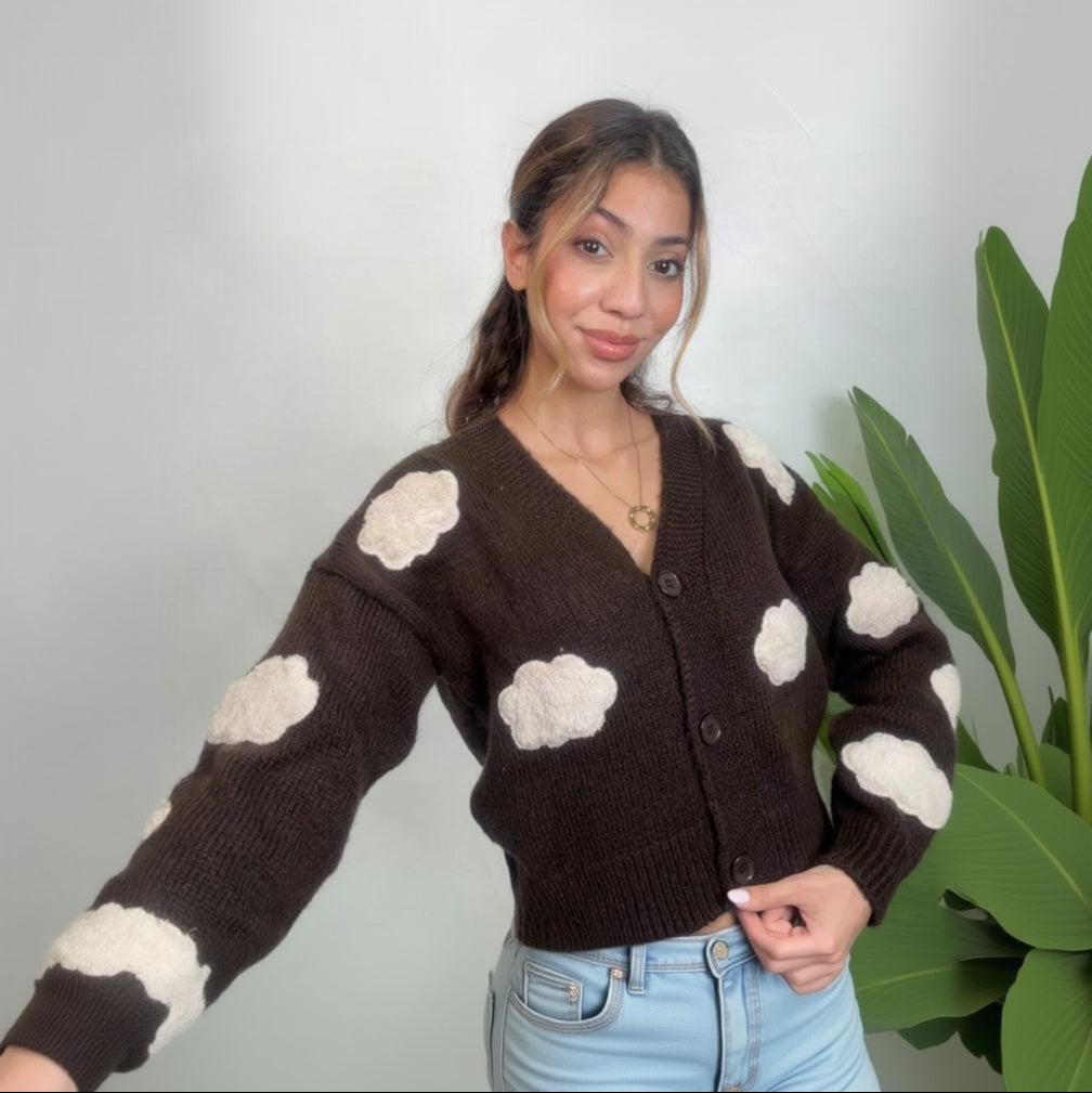 Brown cloud knit cardigan with one arm stretched out showing the cream cloud sleeve patches