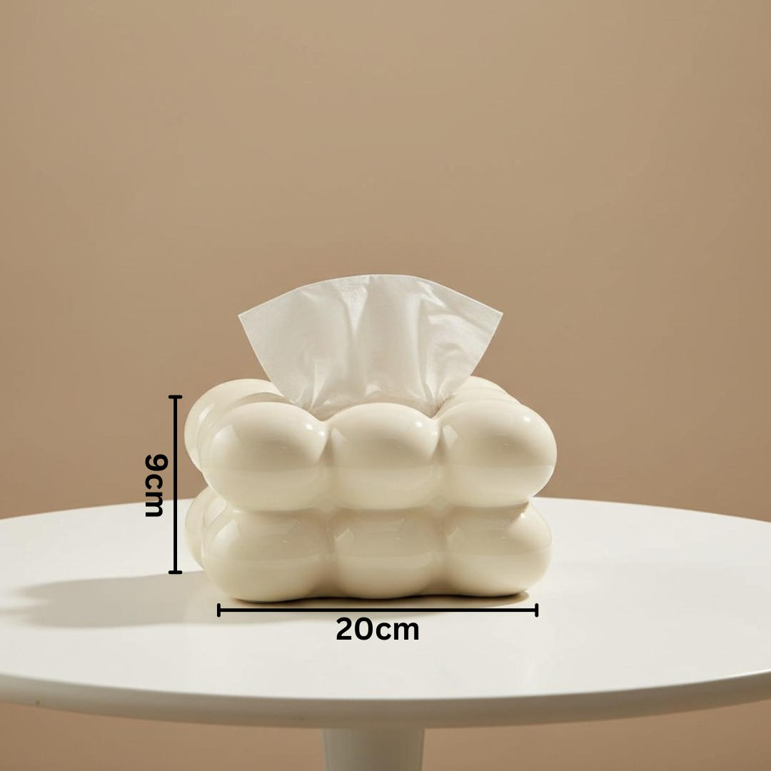 Glossy cream bubble tissue box on a round white table, a tissue pulled up, 20cm by 9cm