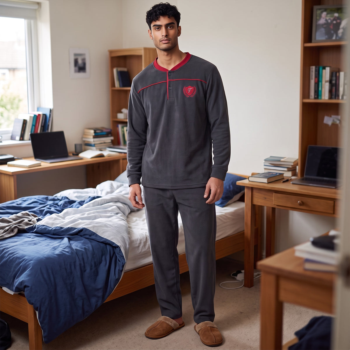 Men's charcoal fleece pyjama set with a red collar, red piping and an embroidered crest