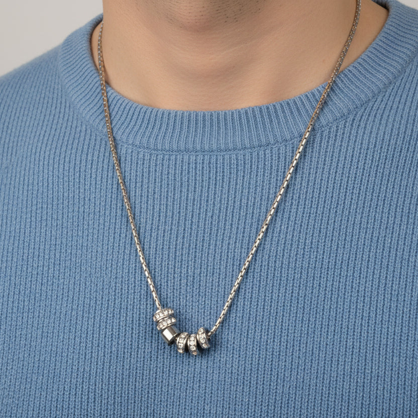 Silver chain with crystal set barrel beads worn over a blue jumper, Jack Gifts Online Lebanon