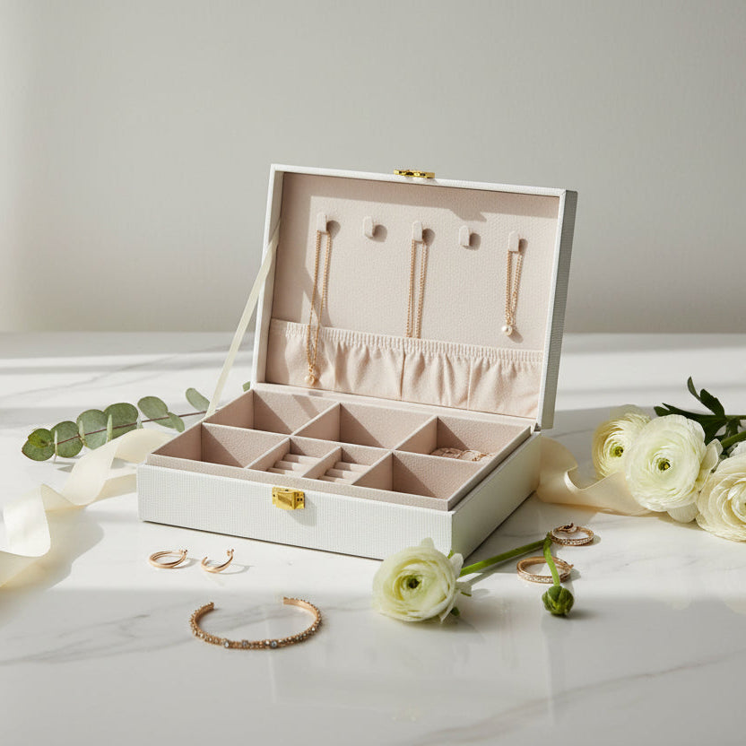 Cream jewelry box open to show five necklace hooks, an elastic pouch and ring slots