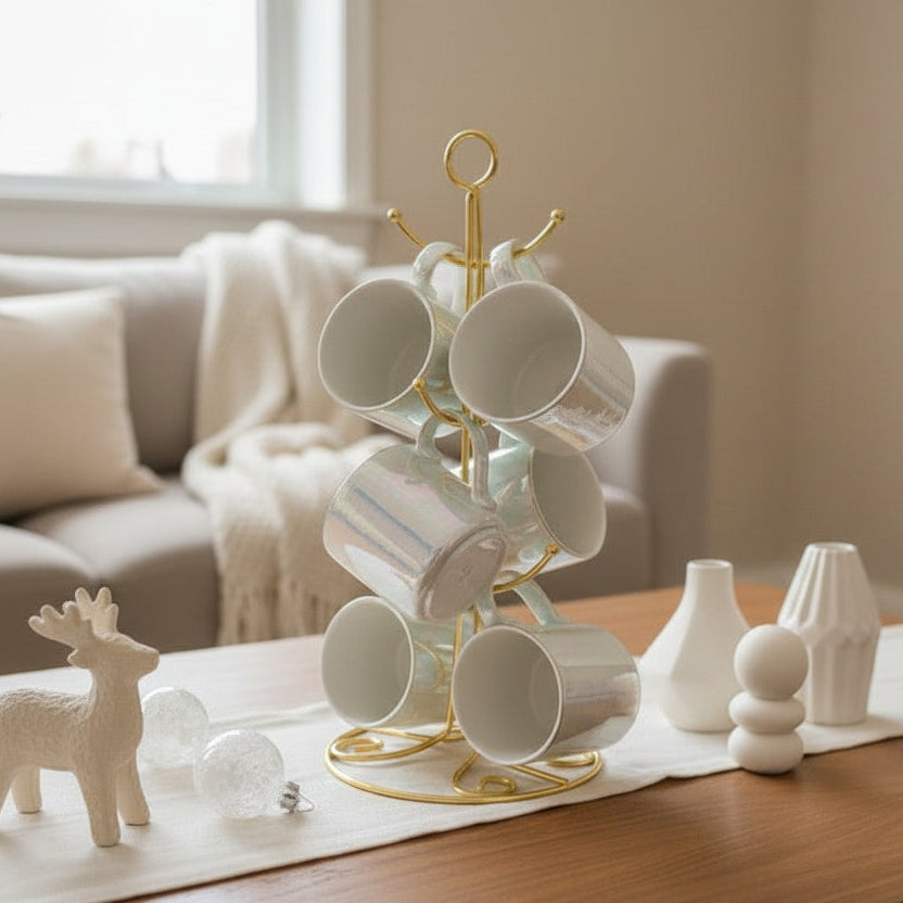 White iridescent ceramic mugs hanging on a gold wire mug tree stand