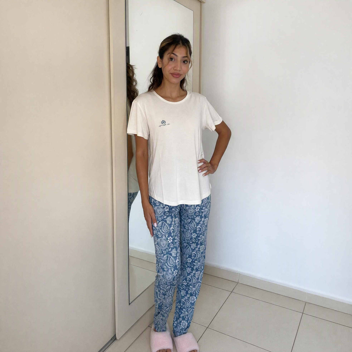 Women's cream tee paired with blue paisley print pyjama trousers