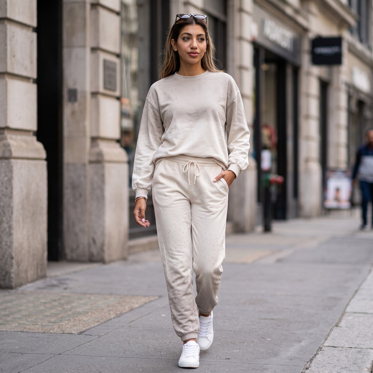 Cream rhinestone studded jogging set worn walking on a city street