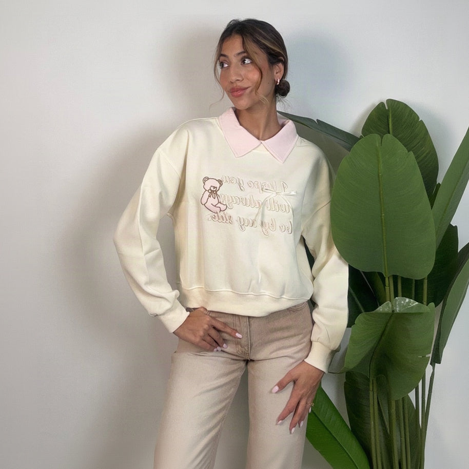 Pink shirt collar and satin ribbon bow on the cream embroidered sweatshirt