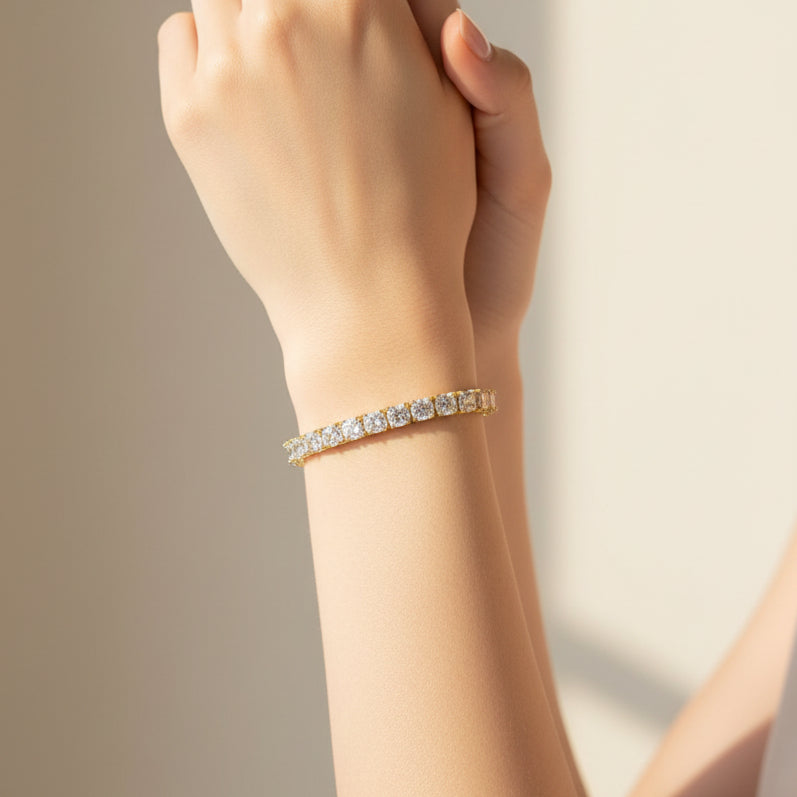 Gold tennis bracelet with diamond accents worn by a person
