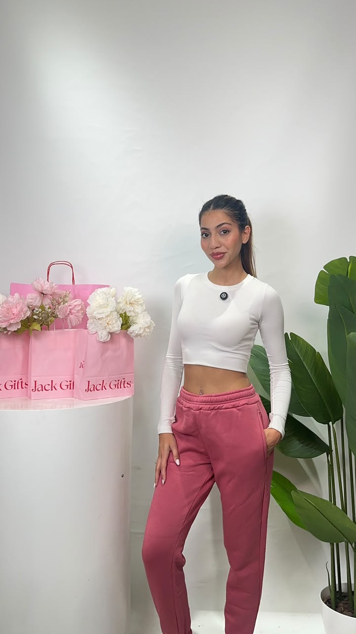 Muted raspberry pink joggers in a walking pose with one hand tucked into the side pocket