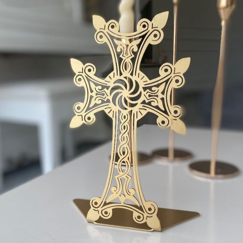 Ornate gold khachkar of open filigree with budded arms on a diamond shaped plate