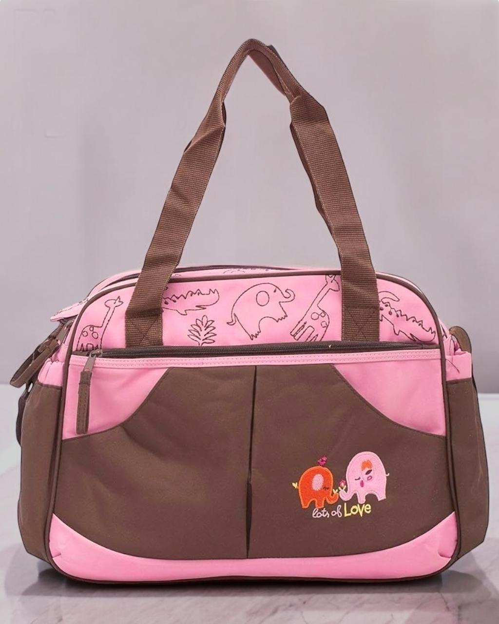 Pink and brown baby changing bag with elephant embroidery, safari animal print panel and two carry handles