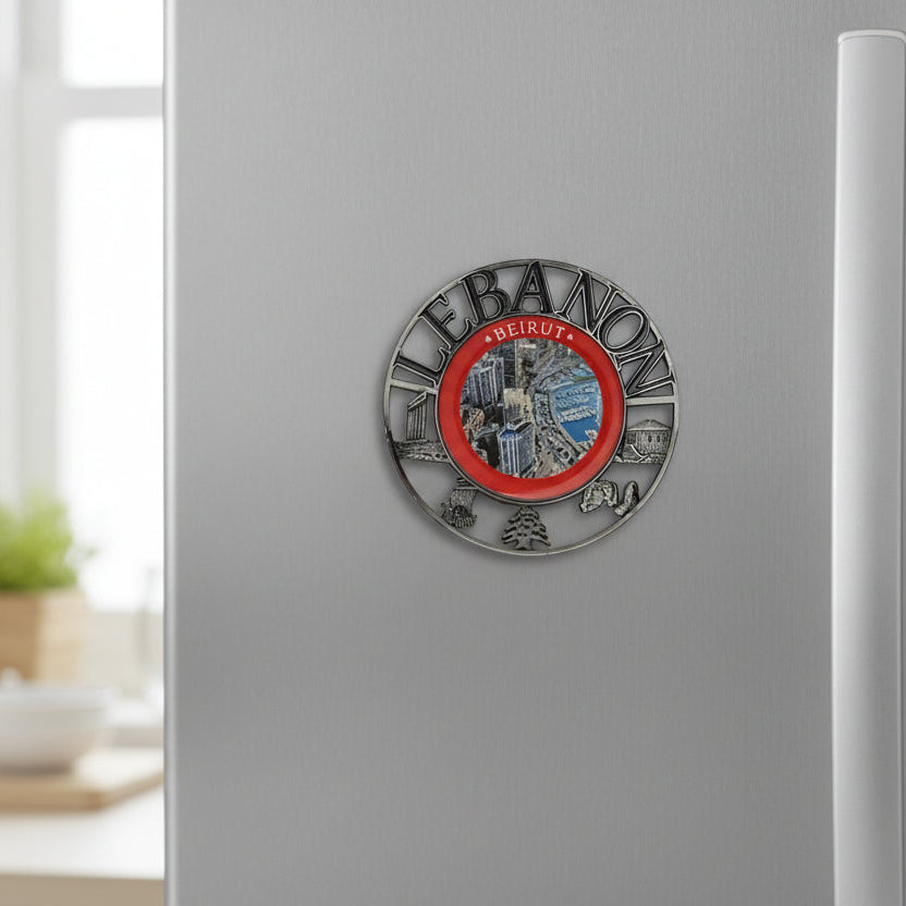 Silver medallion magnet ringed with Lebanese landmarks around an aerial view of Beirut