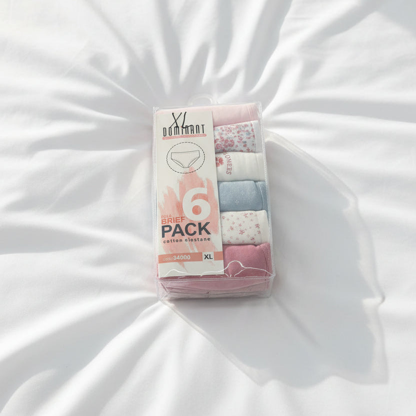 Pastel floral briefs boxed in a clear pack, lying on white bedding