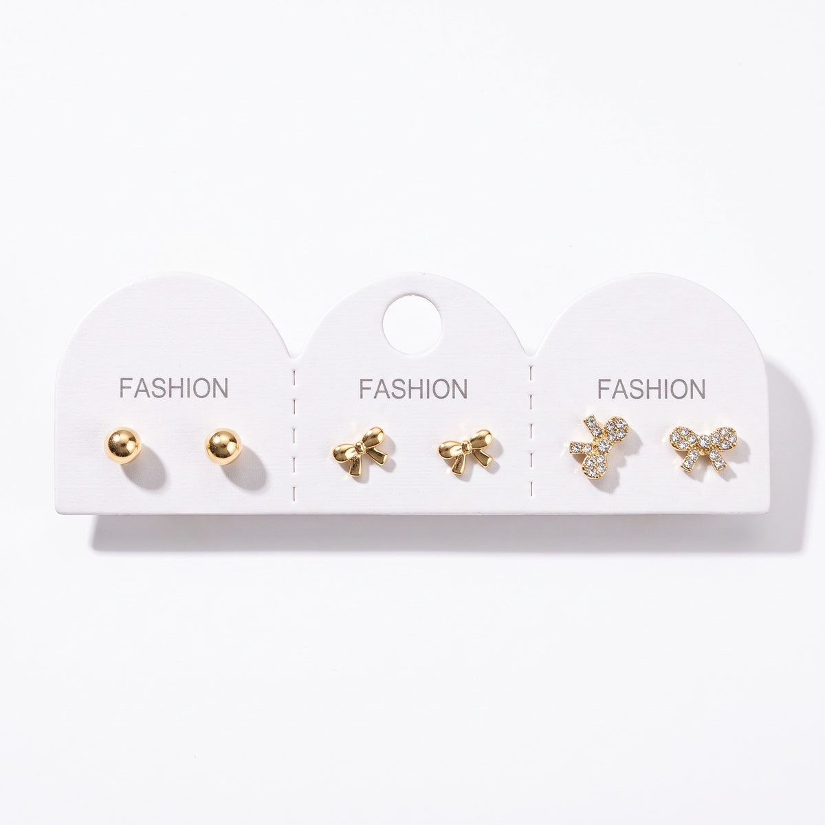 Gold ball studs with a plain bow pair and a crystal pave bow pair on one card
