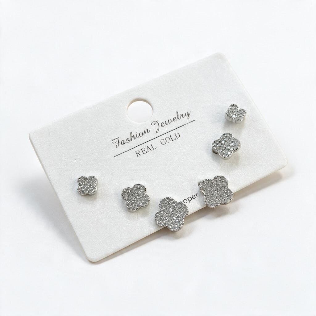 Silver pave crystal clover studs in three graduated sizes on a white display card
