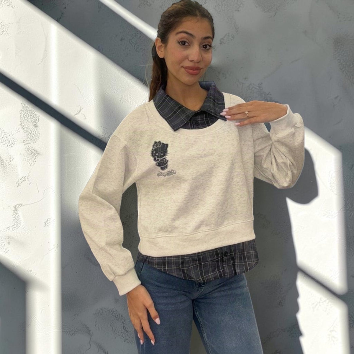 Grey marl sweatshirt in side light showing the balloon sleeve and ribbed cuff