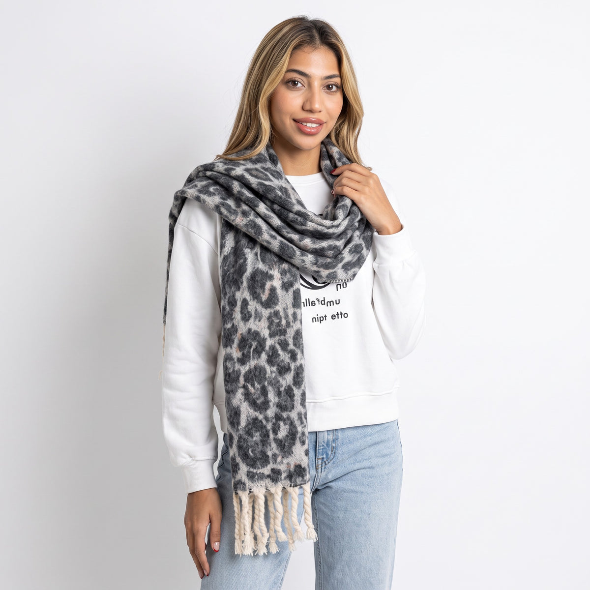 Grey and cream leopard print winter scarf worn looped twice with thick knotted fringe