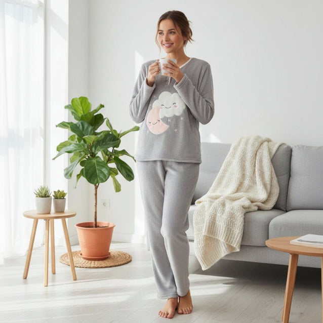 Grey fleece pyjama set with a cloud and pink moon applique, worn standing while holding a mug
