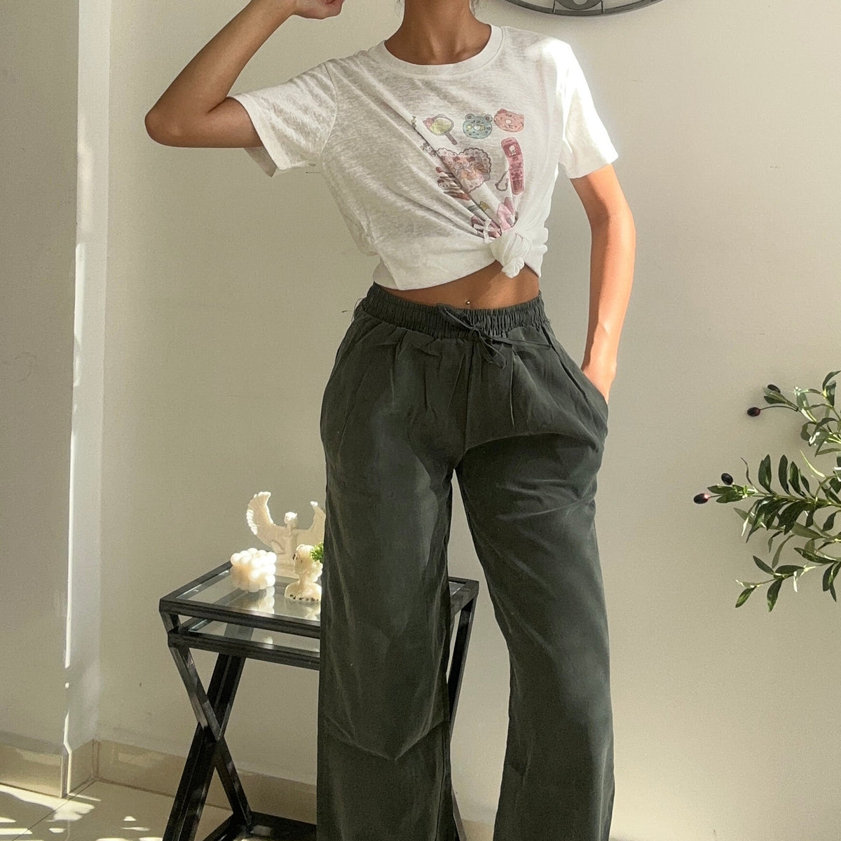 Heart print crop tee knotted at the hem with khaki drawstring trousers