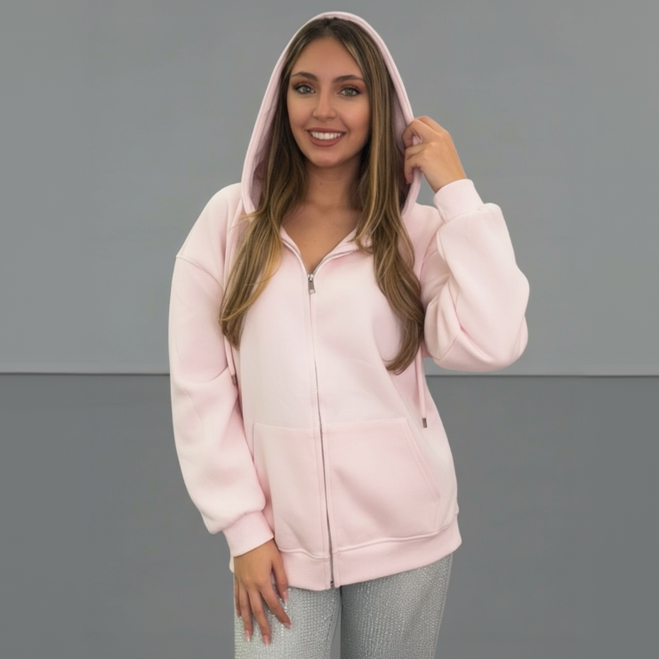 Woman wearing a pink jacket against a grey background