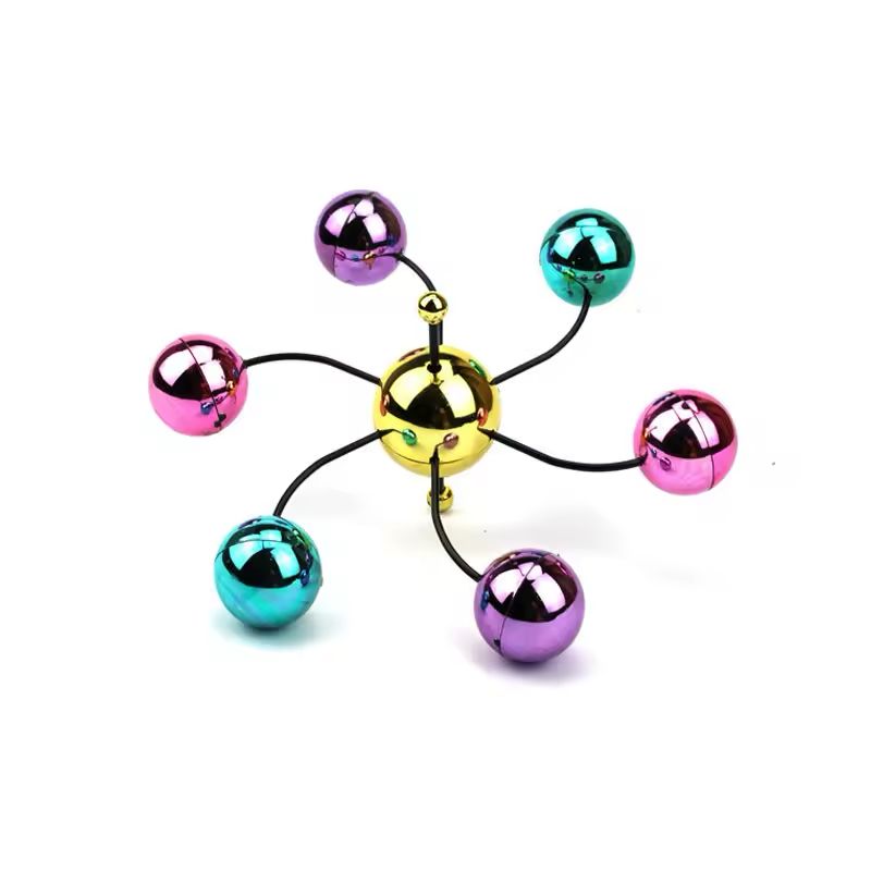 Close up of the gold hub with six curved wire arms holding chrome coloured balls