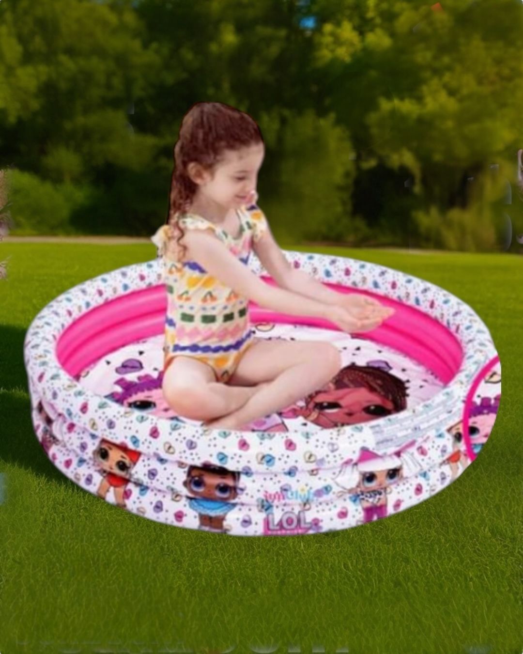 White three ring inflatable kids pool printed with big eyed cartoon dolls, girl sitting inside on a lawn