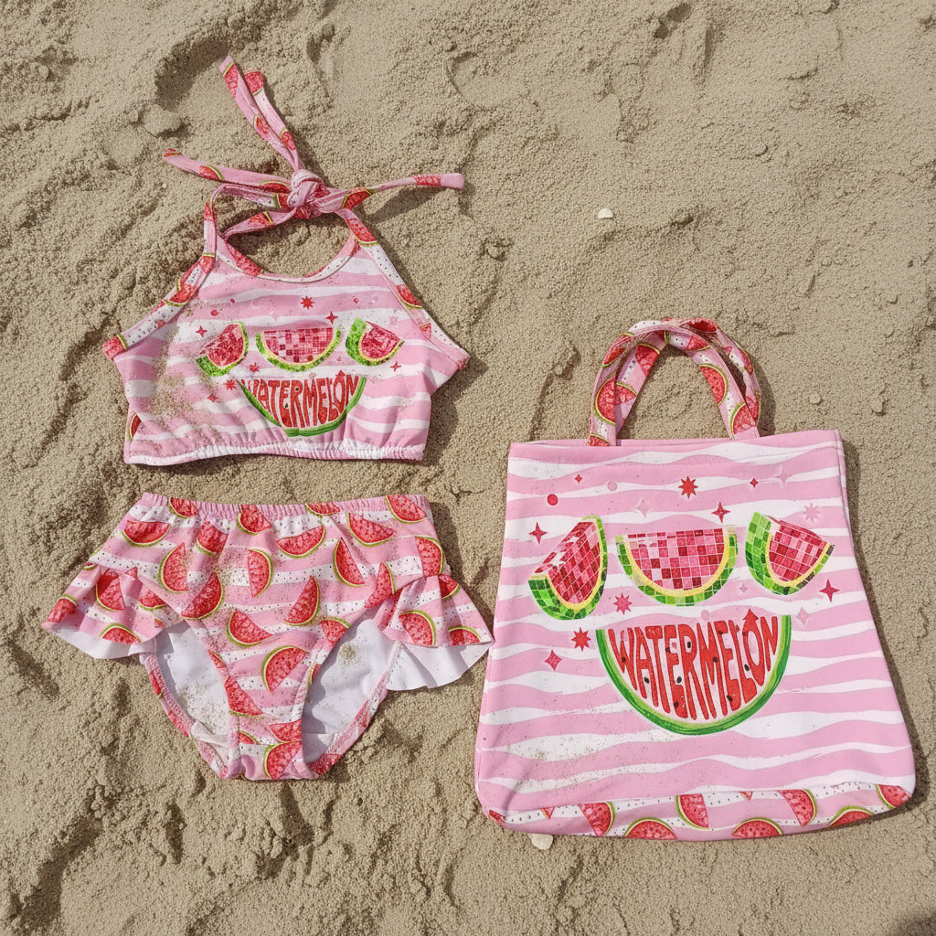 Children's swim set with pink watermelon design on the sand