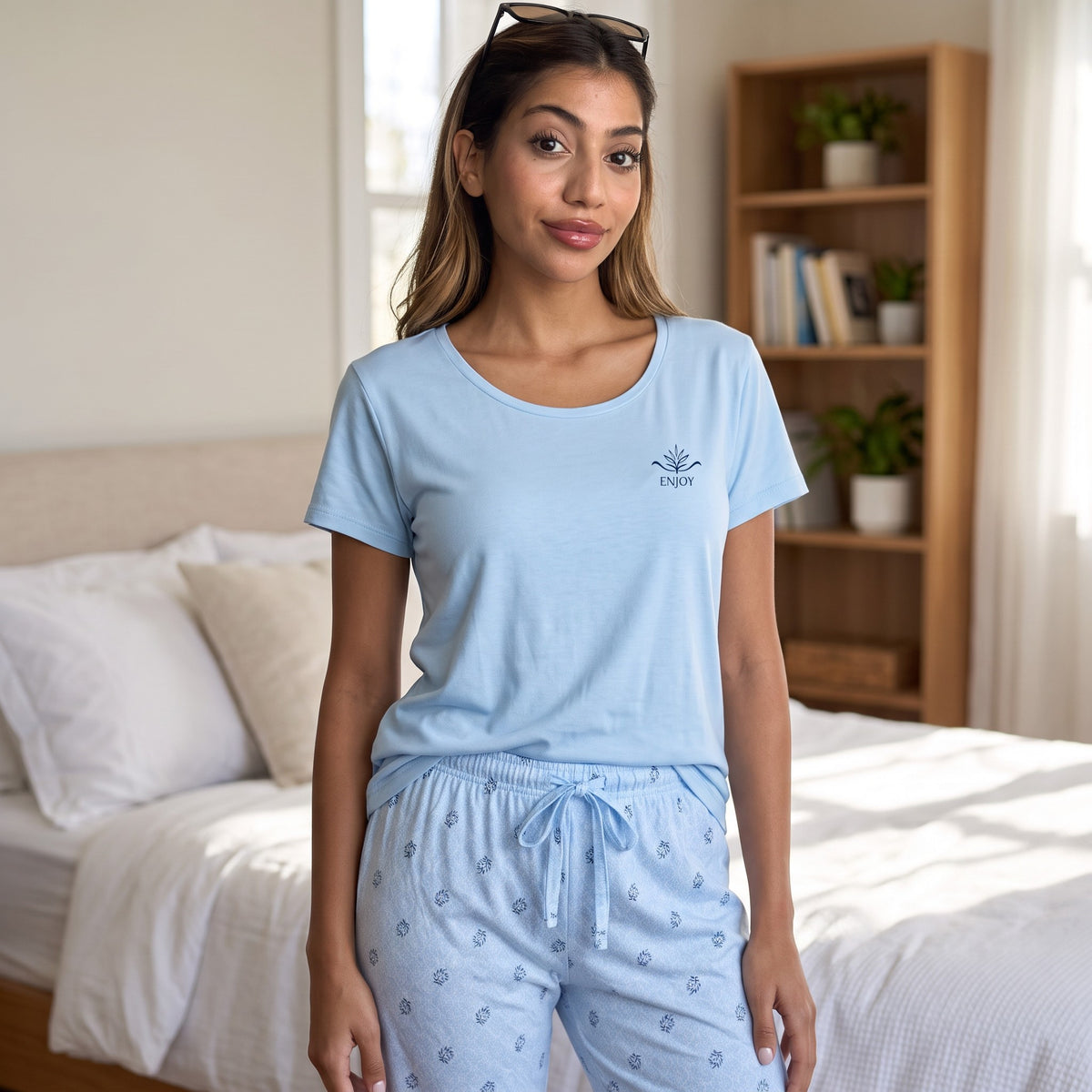 Light blue short sleeve pyjama tee with navy Enjoy emblem and leaf print trousers