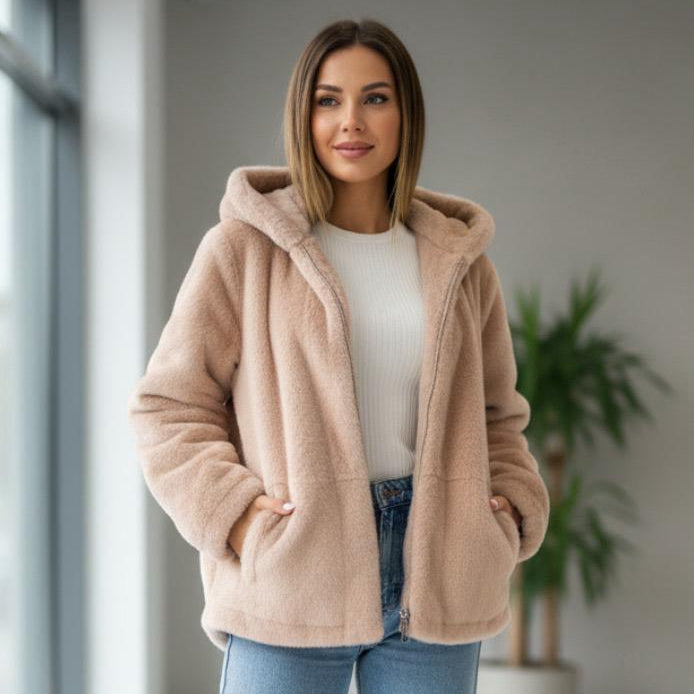 Long beige faux fur hooded jacket worn open over a casual outfit