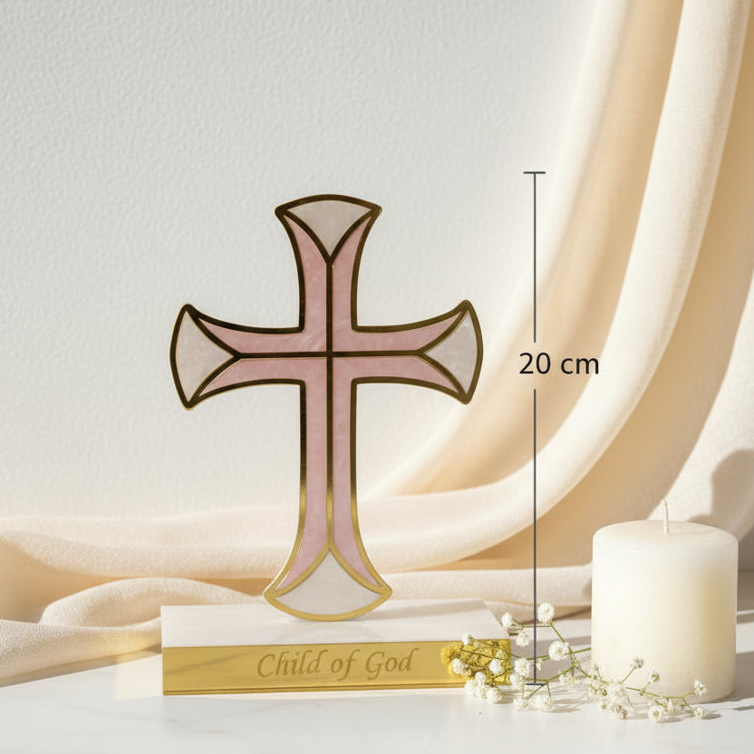 Blush pink nacre cross in a gold frame beside a pillar candle, marked 20 cm