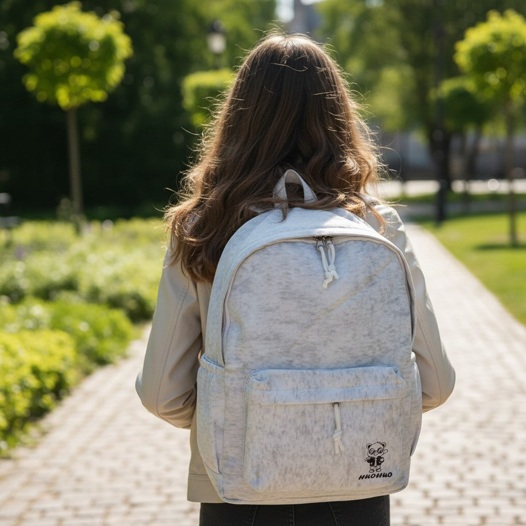 Girl wearing a light grey marled school backpack, Jack Gifts Online Lebanon