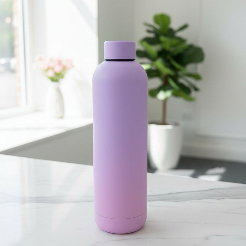 Lilac to pink matte 750ml insulated bottle on a marble counter with roses